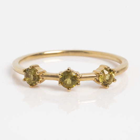 The Solid Gold Tourmaline Trio Stacking Ring features three round yellow tourmalines set in prongs, displayed on a white background.