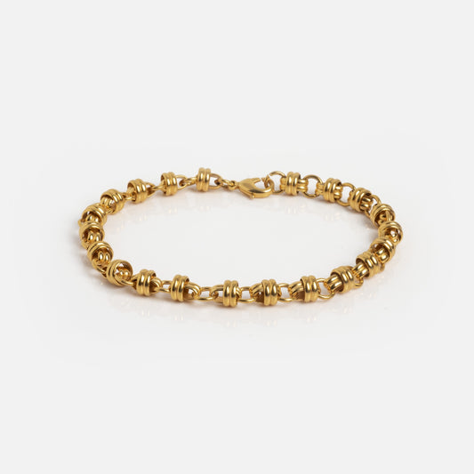 The Lover's Link Rolo Chain Bracelet features interlocking gold-toned links with knot designs and a secure lobster clasp, shown against a white background.