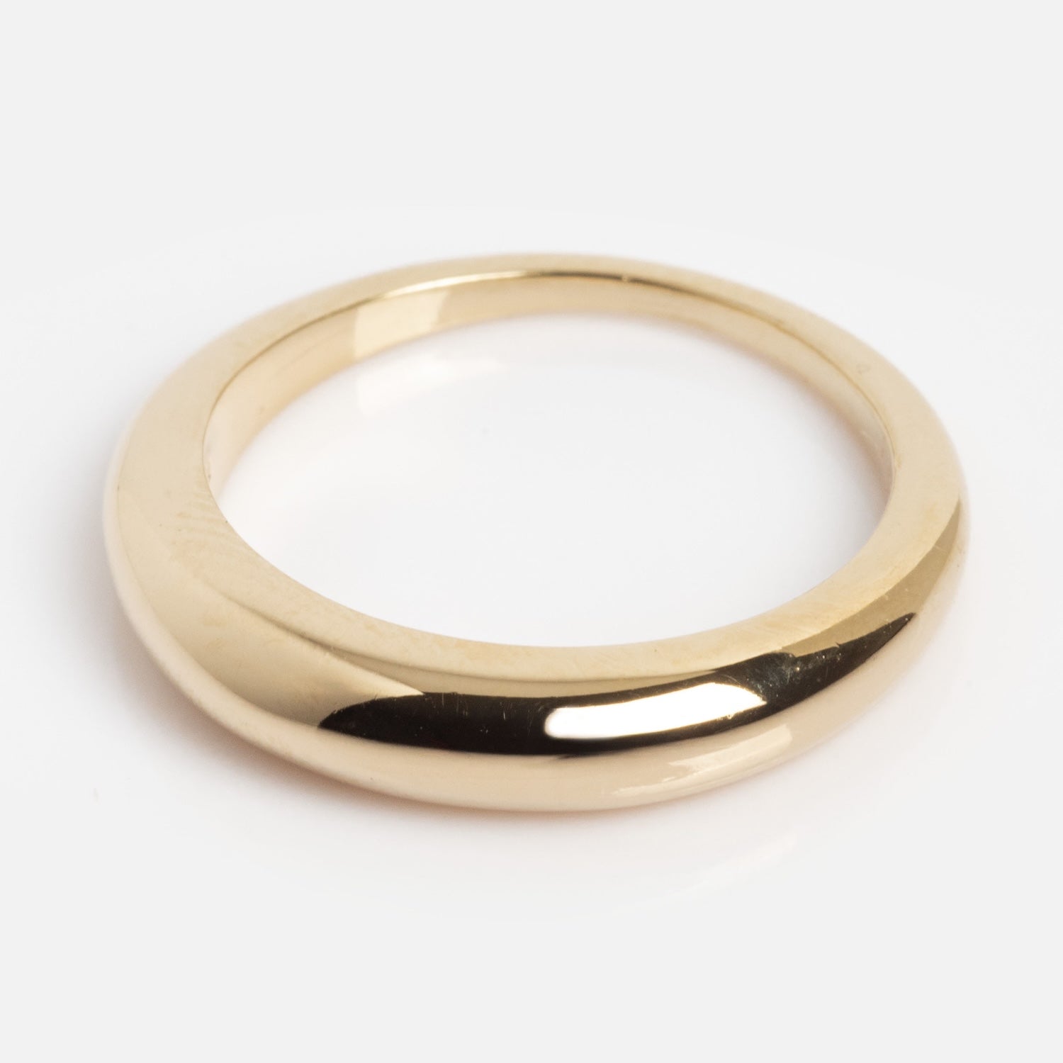 The Pinky Promise Ring in Gold is shown on a white background, featuring a plain, polished 14K gold-plated band with a smooth, rounded surface and a classic, minimalist design without embellishments.
