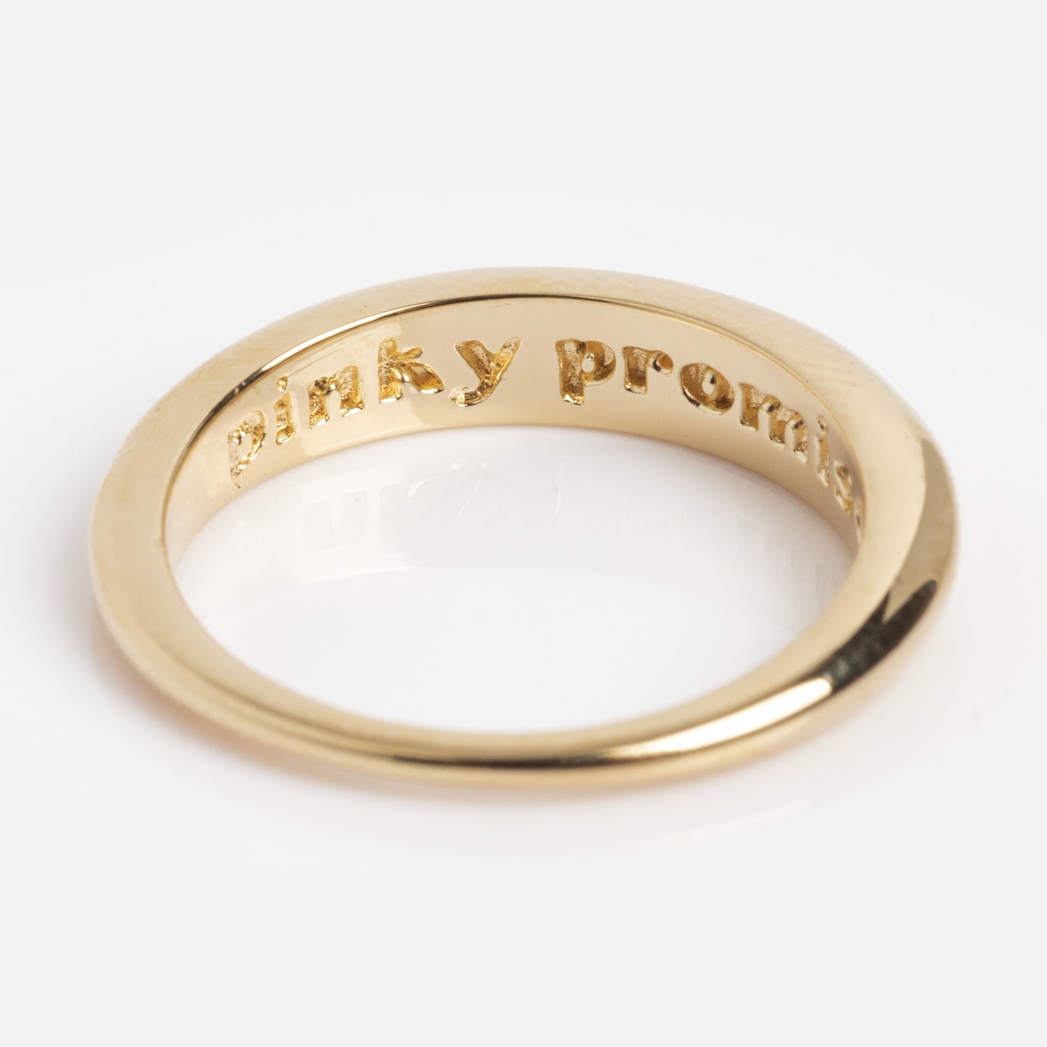 The Pinky Promise Ring in Gold, featuring "pinky promise" engraved inside, is 14K gold plated and shown against a plain white background.