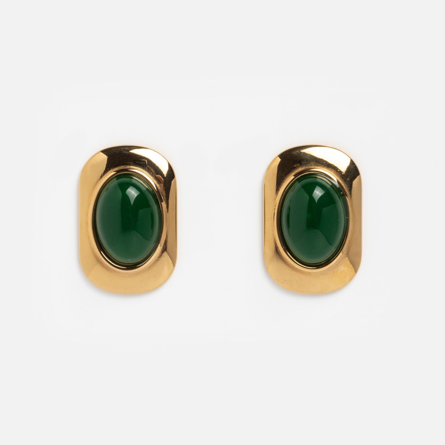 Ashley Earrings: A pair of gold rectangular earrings with rounded corners, each showcasing a glossy dark green oval stone at the center, displayed on a plain white background.
