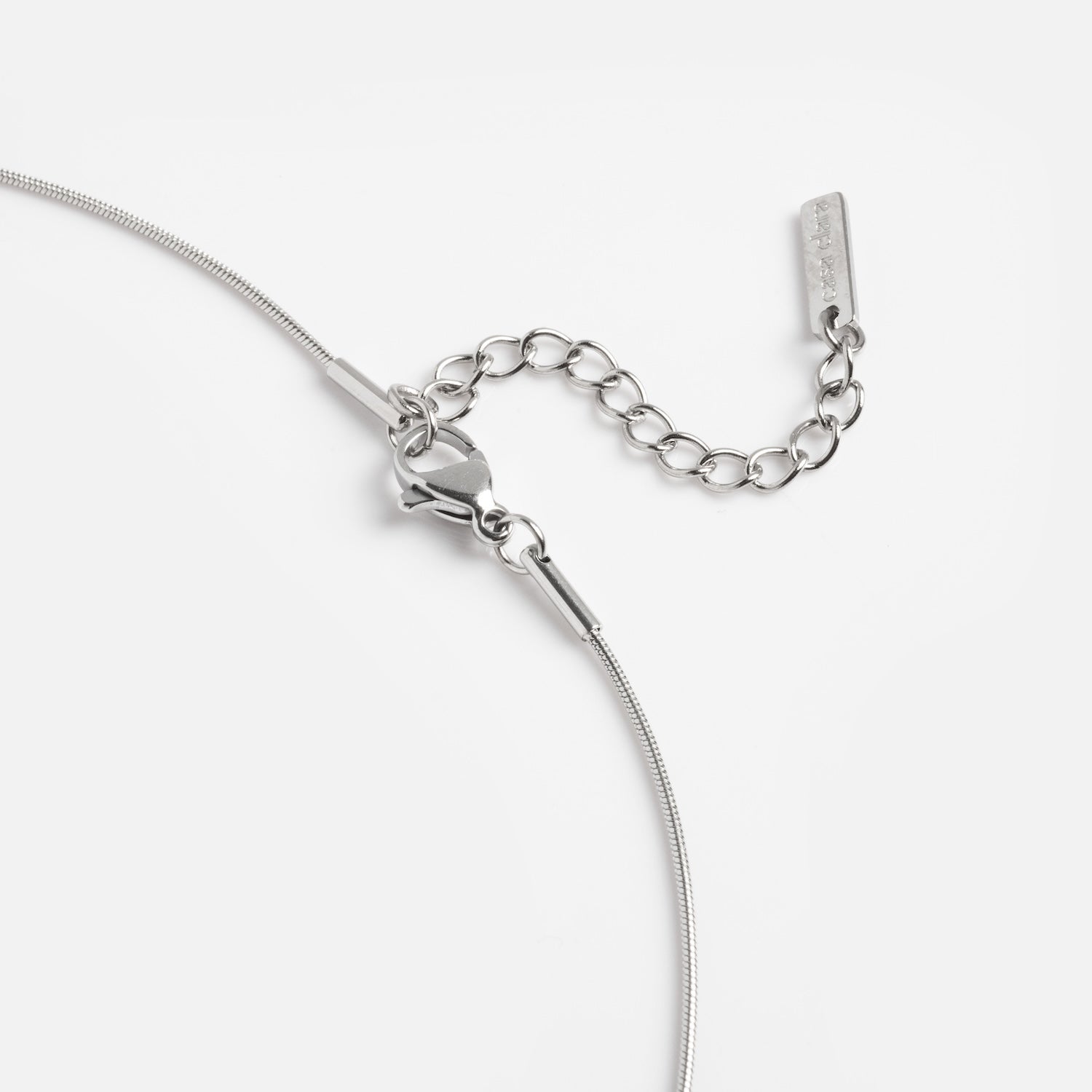 Close-up of the Prism Necklace, featuring a silver lobster clasp and adjustable chain extension, displayed against a plain white background.