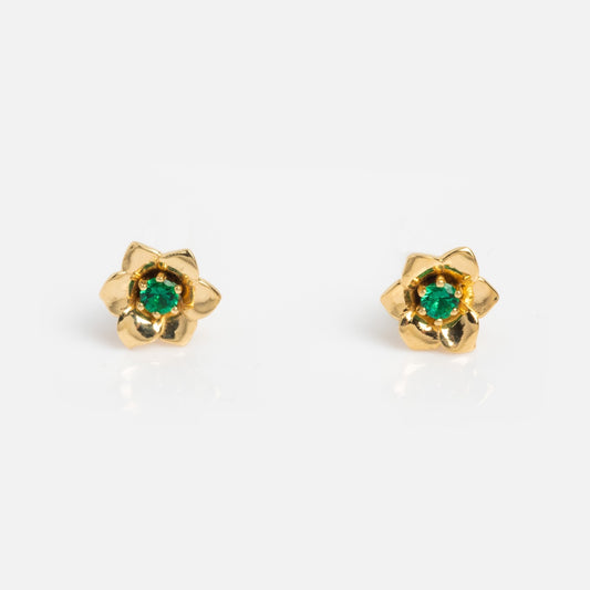 Solid Gold Birth Flower Studs featuring gold flower shapes with green gemstone centers, shown on a plain white background.