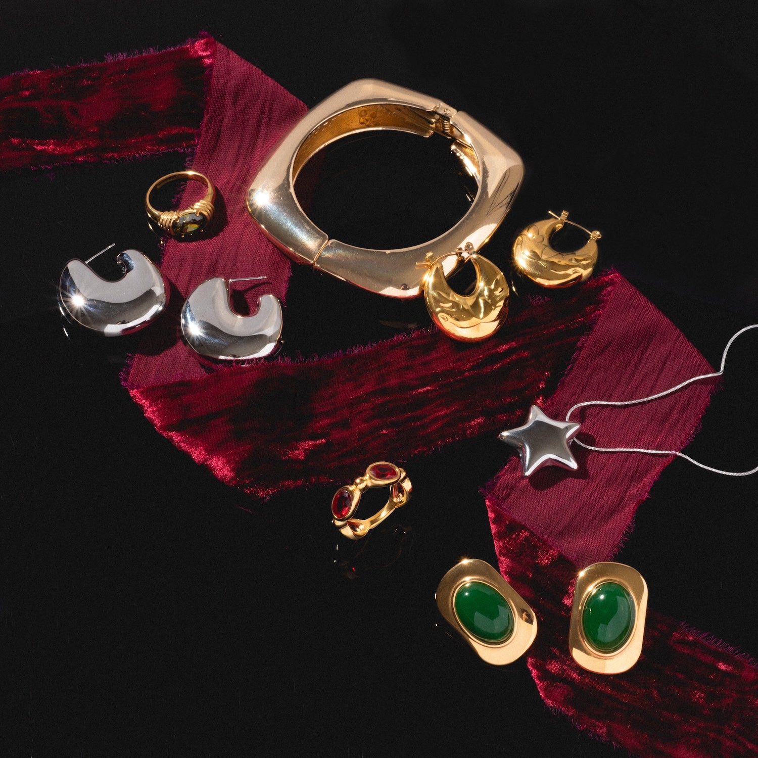 Ashley Earrings, displayed on a black surface with a red velvet ribbon.