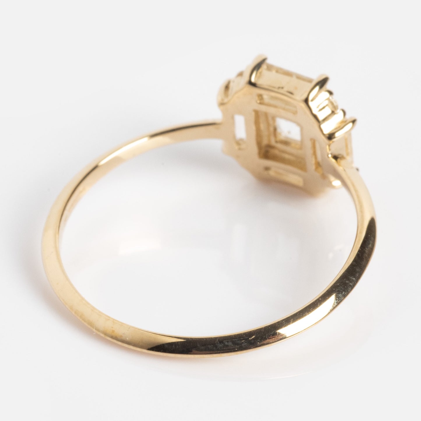 A close-up shows the 14k Vintage Inspired Art Deco Engagement Ring, crafted in recycled gold with an empty rectangular setting, viewed from the side against a plain white background. The setting is designed for a gemstone but remains unadorned.