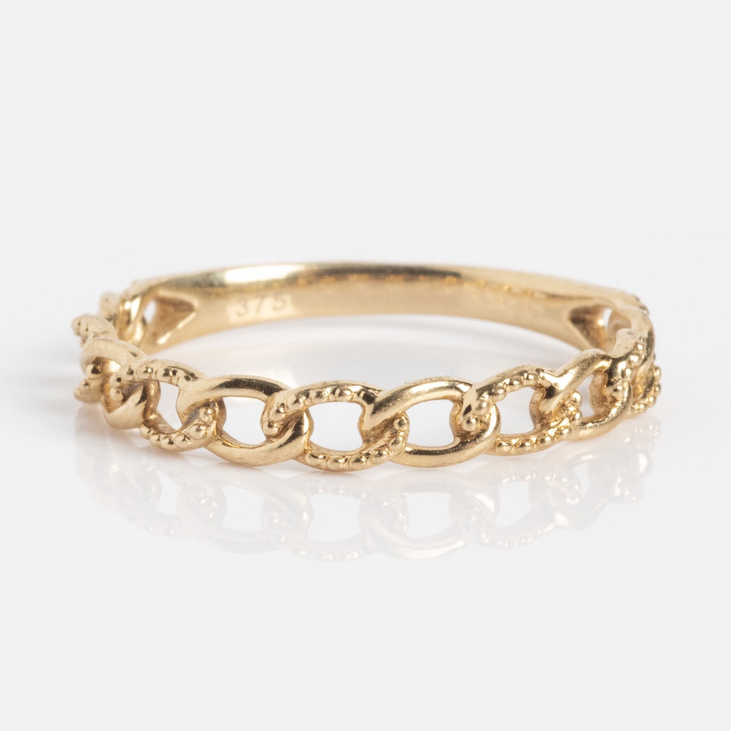 The Solid Gold Textured Chain Link Ring, crafted in 9k gold with interlocking links, is displayed on a white background.