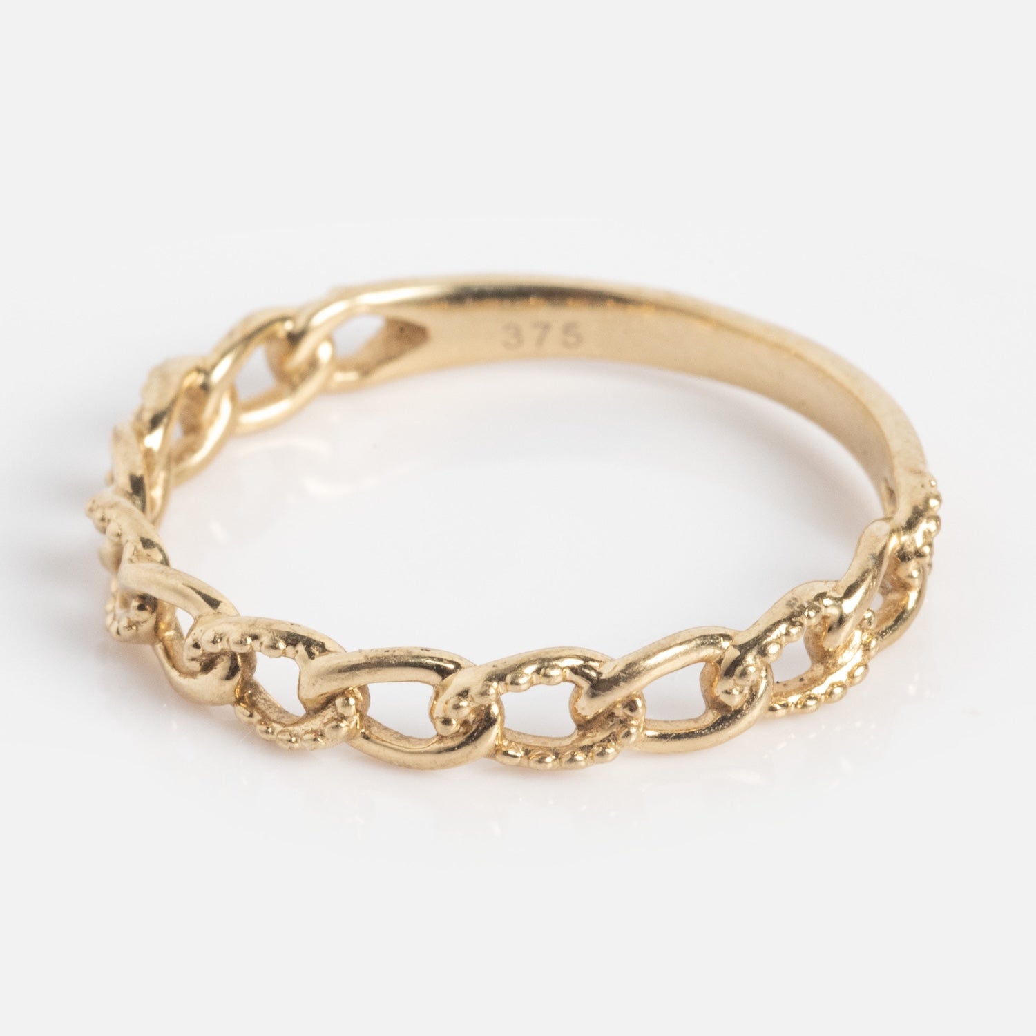 The Solid Gold Textured Chain Link Ring is a delicate 9k gold piece with interlocking chain links and fine textured details, shown against a white background.