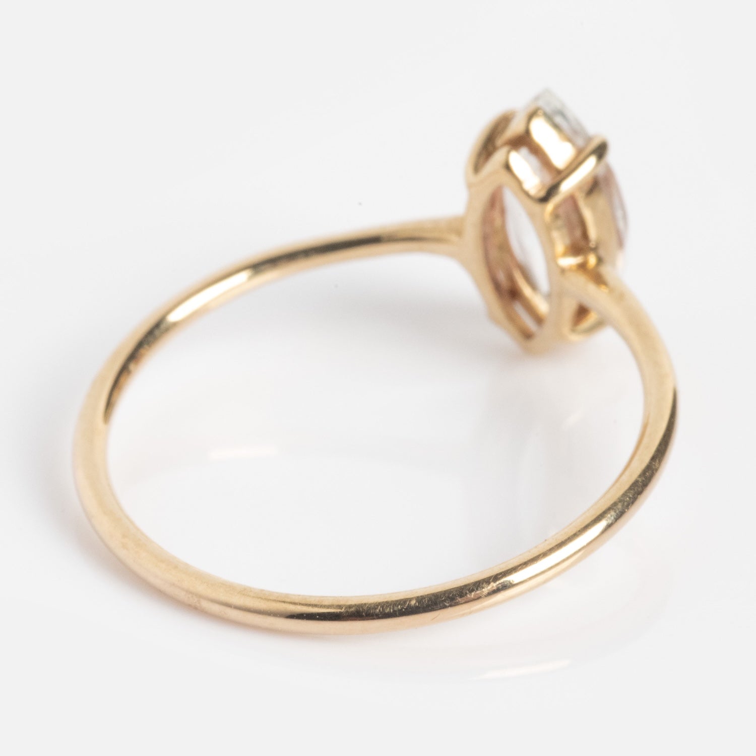 A close-up of the Solid Gold Gemstone Marquise Ring in White Topaz featuring a slim band and a single marquise-cut stone in a raised prong setting, displayed on a white background.