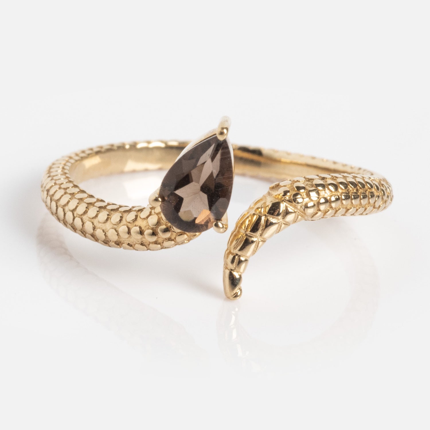 The Solid Gold Smoky Quartz Snake Ring for Transformation features textured scales and a teardrop smoky quartz near the head, making this Local Eclectic exclusive gleam elegantly against a white background.