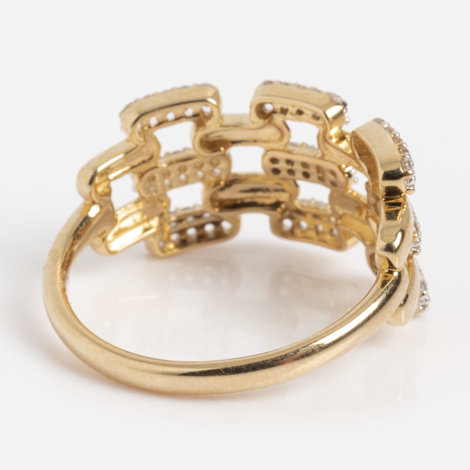 The Solid Gold Mirrored Light Diamond Statement Ring features an intricate linked chain design with small embedded diamonds, displayed from an angled side view on a white background.