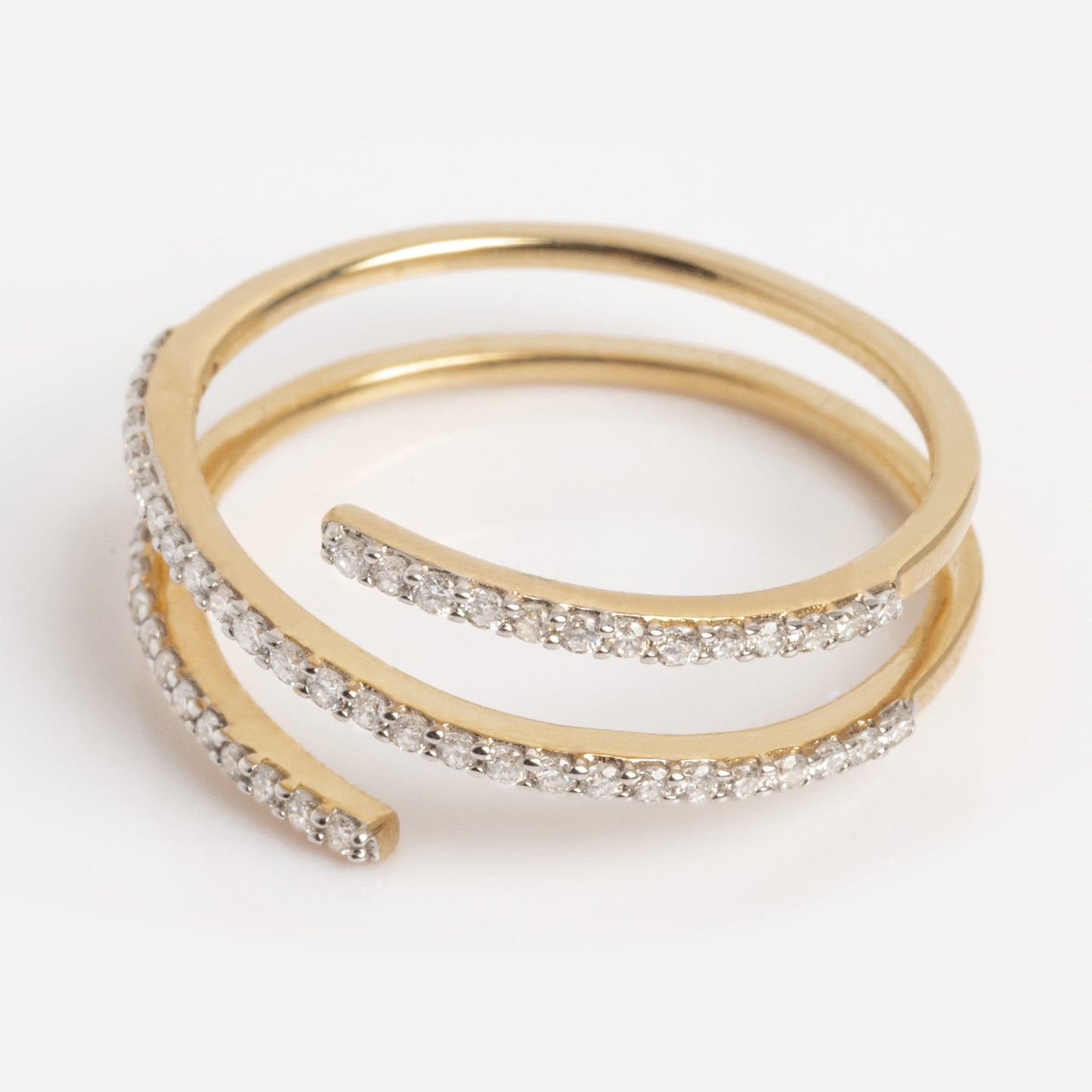 The Solid Gold Shifting Shimmer Diamond Wrap Ring features two overlapping gold bands, each adorned with sparkling diamonds, shown against a plain white background.