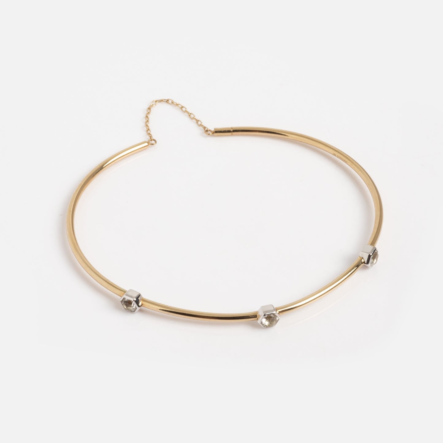 The Solid Gold Geometric Glimmer Mixed Metal Bracelet features three evenly spaced silver-toned cubic accents and is displayed on a plain white background.
