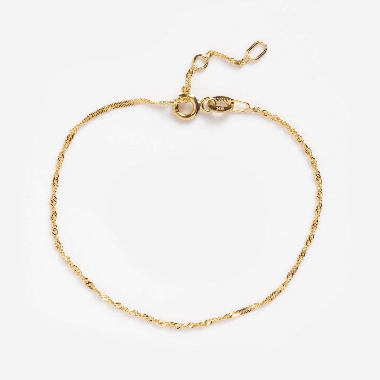 The Solid Gold Twisted Chain Bracelet features a delicate 9k gold twisted chain with an adjustable clasp and extension links, shown on a white background.
