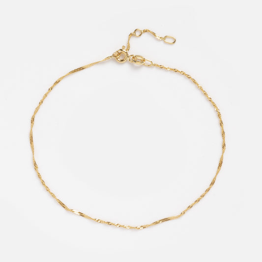 The Solid Gold Twisted Chain Anklet features a delicate 9k gold twisted chain with a small adjustable clasp, shown on a clean white background.