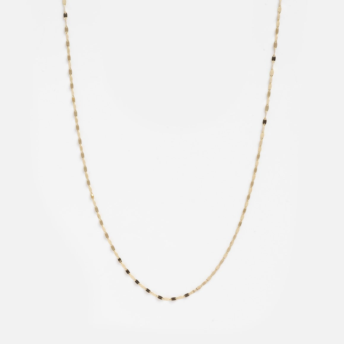 The Solid Gold Sparkle Link Chain is a delicate 14k gold necklace with small, evenly spaced black beads, shown against a plain white background.