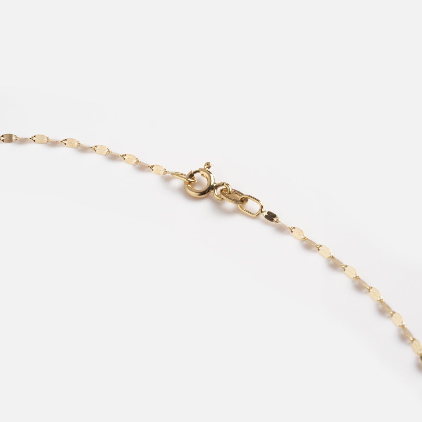 A close-up of the Solid Gold Sparkle Link Chain, a delicate 14k gold necklace with a spring ring clasp, displayed against a white background—an effortlessly timeless accessory.