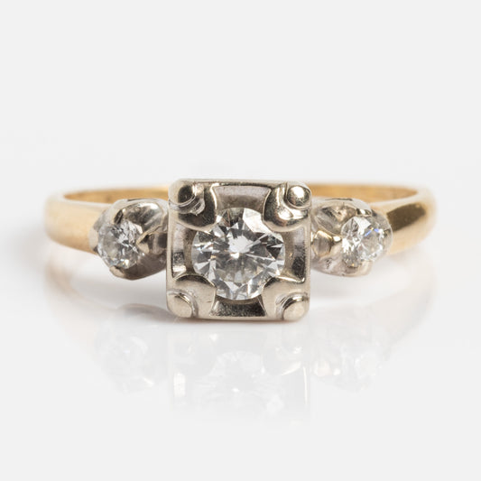 The Vintage 14k Square Set Diamond Trilogy Ring, size 6, features three round diamonds with the center diamond in a square ornate setting, flanked by two smaller diamonds, shown against a white background.