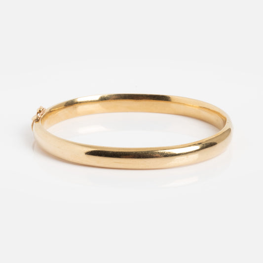 The Vintage 9k Classic Bangle features a smooth, rounded gold design and is shown against a white background.