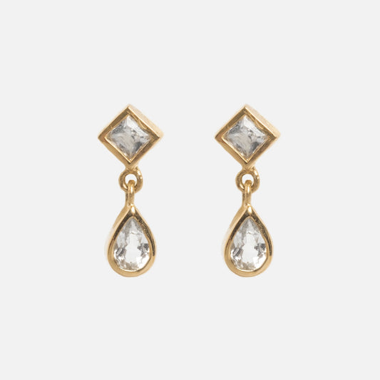 Solid Gold Radiant White Topaz Drop Studs feature square white topaz at the top and teardrop-shaped clear stones below, perfect for ear stacking. Shown on a plain white background.