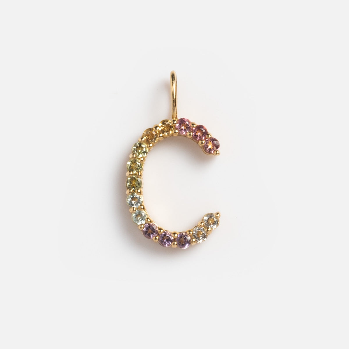Solid Gold Pastel Gemstone Letter Charm Sample: 9k yellow gold pendant in the shape of “C,” set with small, multicolored gemstones—purple, green, yellow, and pink tourmaline—displayed on a plain white background.