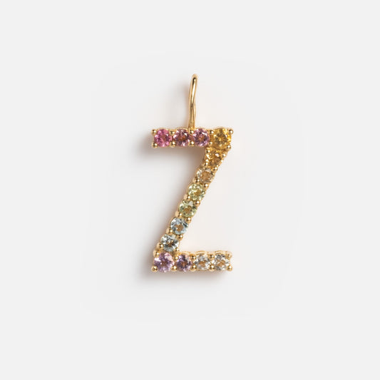The Solid Gold Pastel Gemstone Letter Charm features a gold letter Z adorned with delicate pastel gemstone charms, shown against a plain white background.