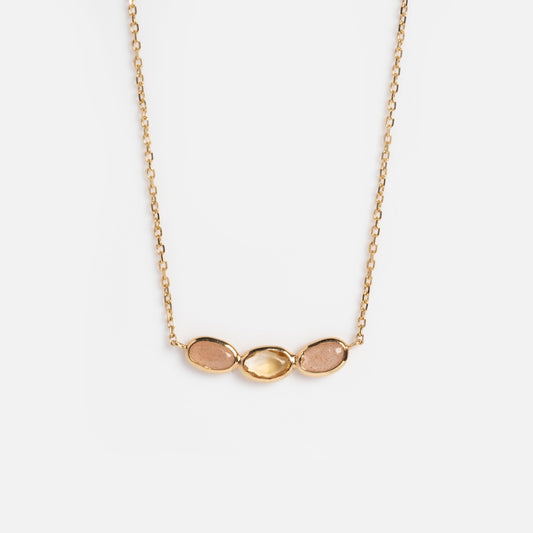 The Solid Gold Morning Light Citrine and Sunstone Necklace by Local Eclectic features three small oval stones—citrine and sunstone—in gold settings, displayed side by side on a plain white background.