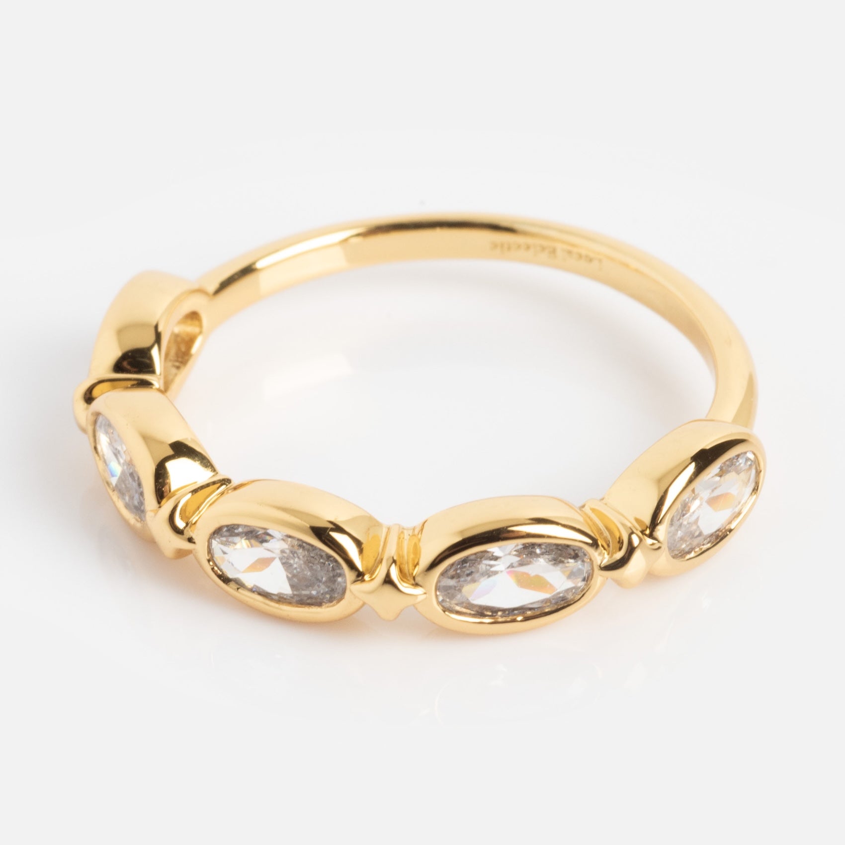 The Bold Moon Beam Stacking Ring is a gold band with four oval clear gemstones in individual bezels, shown on a white background.