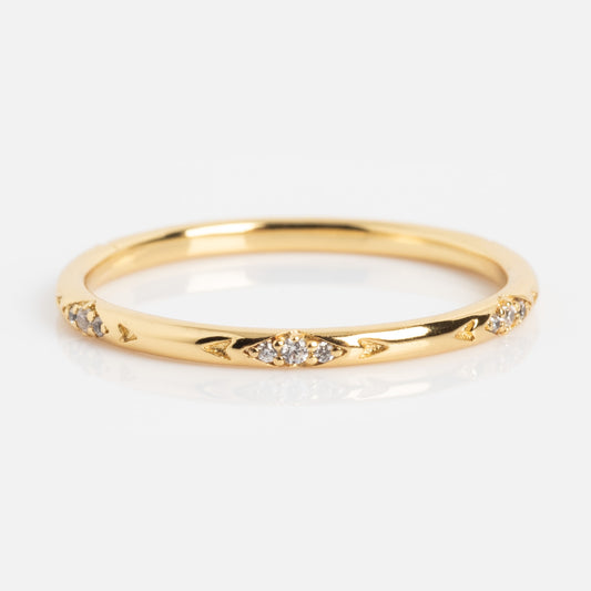 The Dainty Flicker Stacking Ring is a thin gold band adorned with small round diamonds in delicate marquise-shaped engravings, shown on a white background.