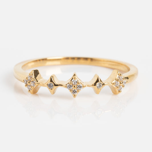 The Dainty Sparkle Stacking Ring features a gold zigzag design with five small diamond clusters set at each peak and in the center, displayed on a white background.