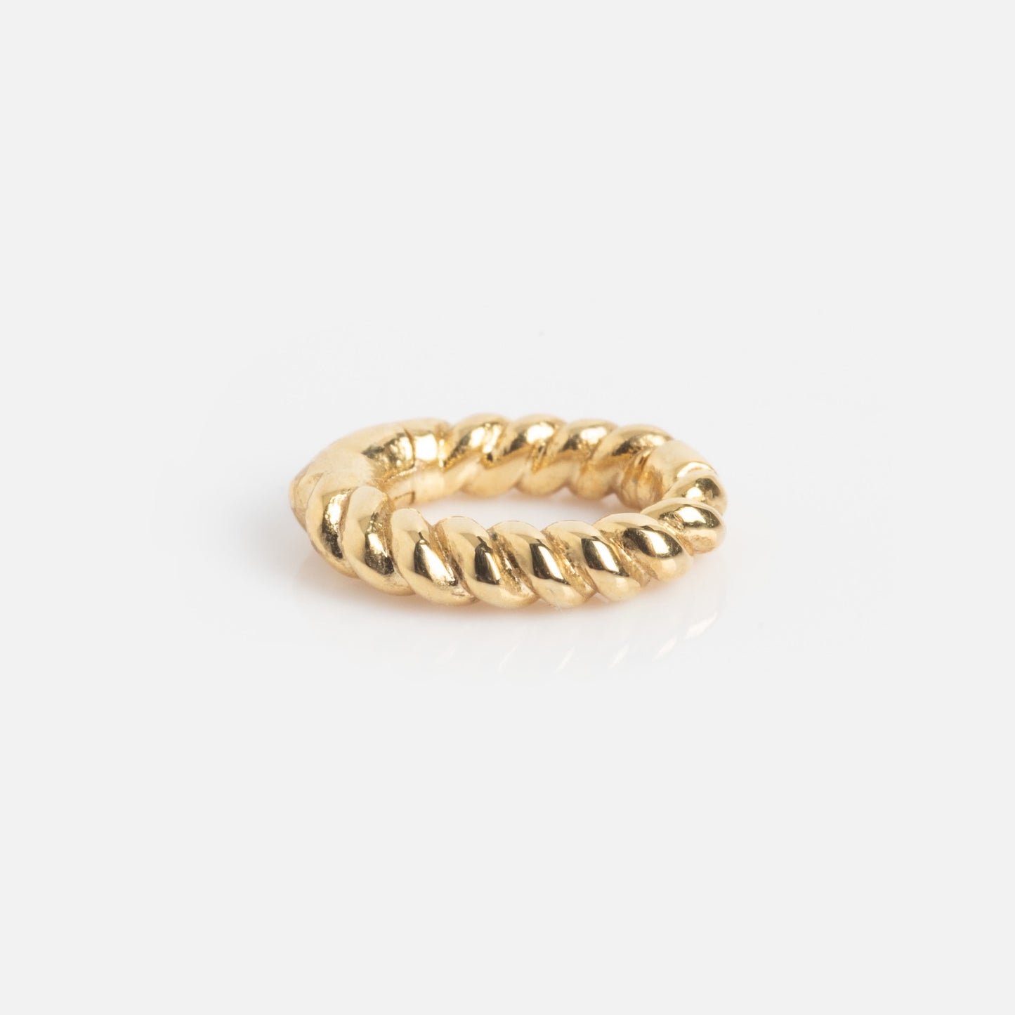 The Ring Clip, featuring a thick, twisted rope design in gold, is displayed on a plain white background.