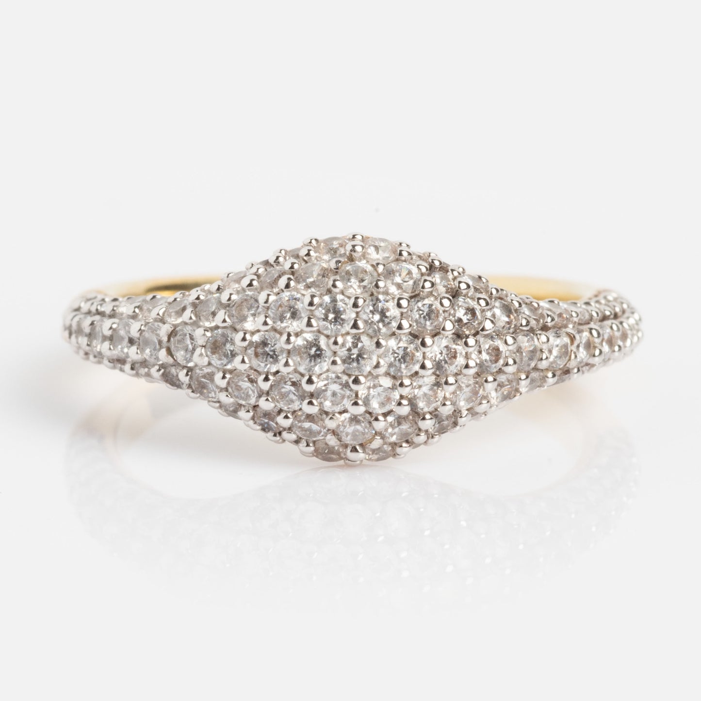 The Pave Signet Pinky Ring features a wide, dome-shaped gold top paved with sparkling white diamonds, displayed on a plain white background.