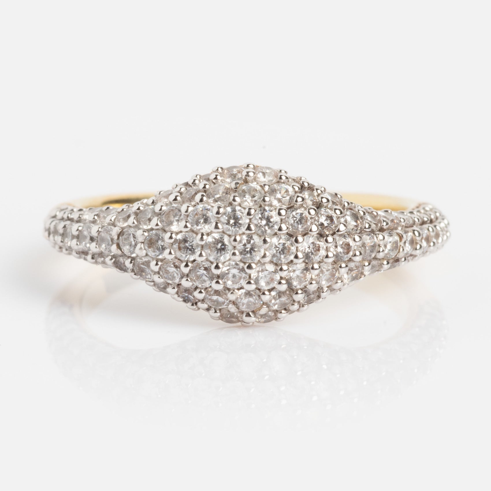 The Pave Signet Pinky Ring features a wide, dome-shaped gold top paved with sparkling white diamonds, displayed on a plain white background.
