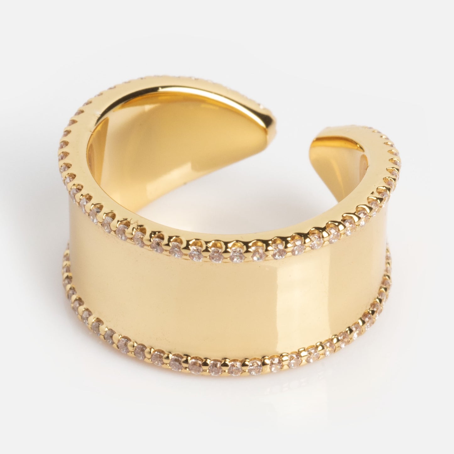 The Open Front Cigar Pinky Ring features a smooth, polished gold finish with rows of sparkling stones along its edges, showcased against a plain light background.