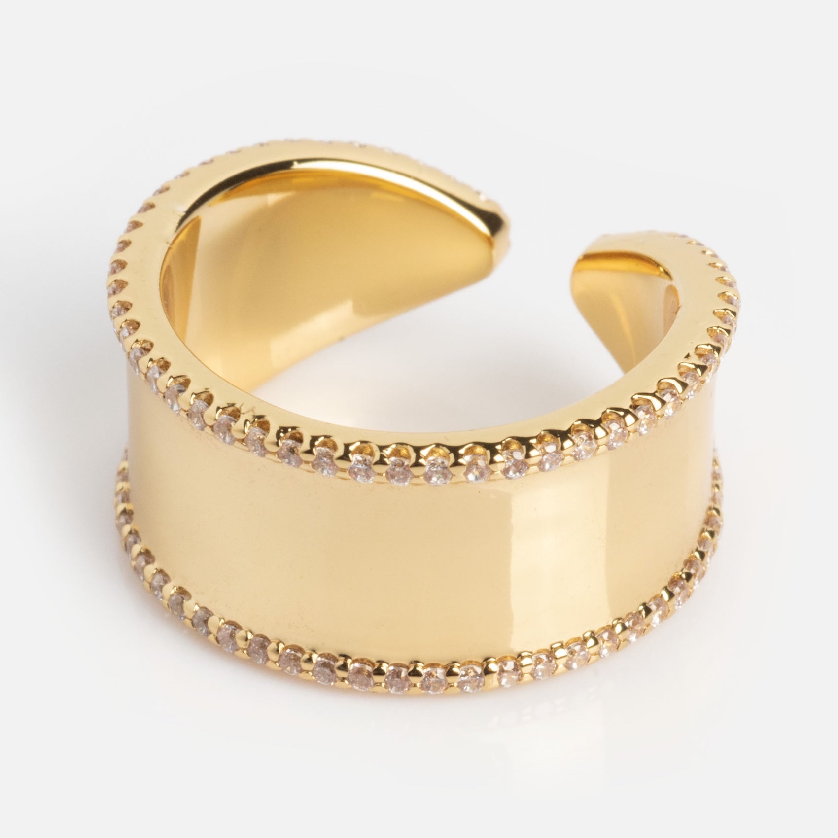 The Open Front Cigar Pinky Ring features a smooth, polished gold finish with rows of sparkling stones along its edges, showcased against a plain light background.