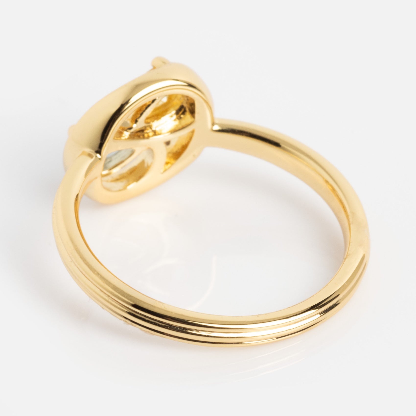 The Eclectic Swirl Pinky Ring features a smooth gold band and a raised oval setting, shown from the side against a white background. The empty setting reveals the ring’s inner structure.