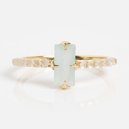 The Solid Gold 2026 March Capsule Delicate Aquamarine Solitaire Ring features a vertical rectangular pale green aquamarine at its center, accented by small round stones along a thin gold band.