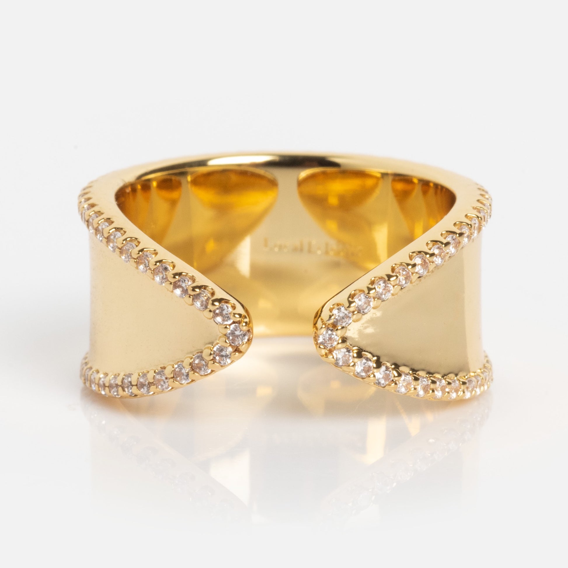 The Open Front Cigar Pinky Ring is a wide gold ring with an open front and wavy, diamond-edged borders, shown on a plain white background.