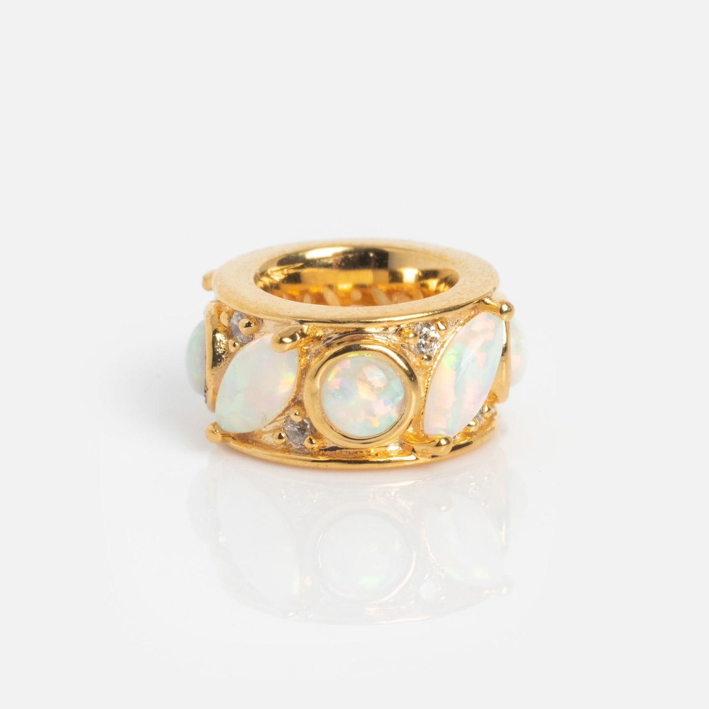 The Shades of You Birthstone Spacer Charm is a wide gold ring featuring multiple oval and round opal gemstones set in prongs, accented with small clear stones, shown against a plain white background.