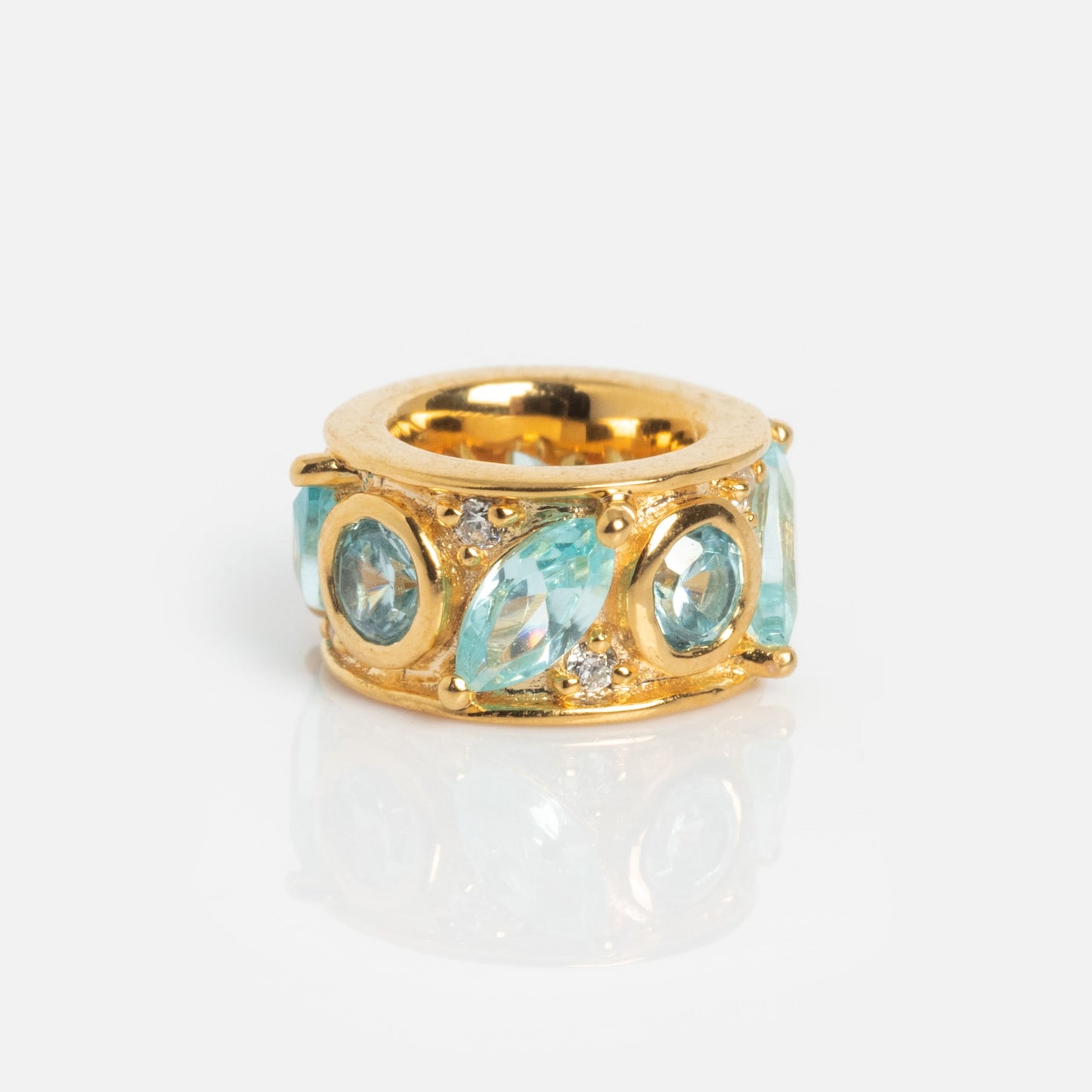 The Shades of You Birthstone Spacer Charm showcases alternating round and marquise-cut light blue stones with small clear accents, displayed on a plain white background.