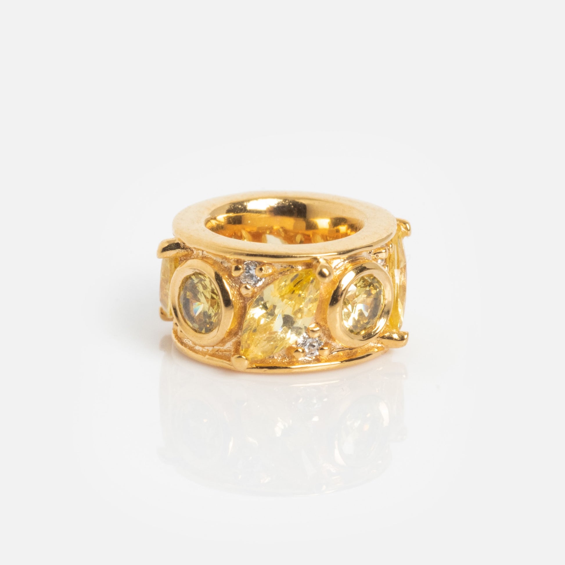 The Shades of You Birthstone Spacer Charm is a wide gold ring featuring three round yellow gemstones and a larger marquise-shaped yellow gem with small clear accent stones, shown against a plain white background.
