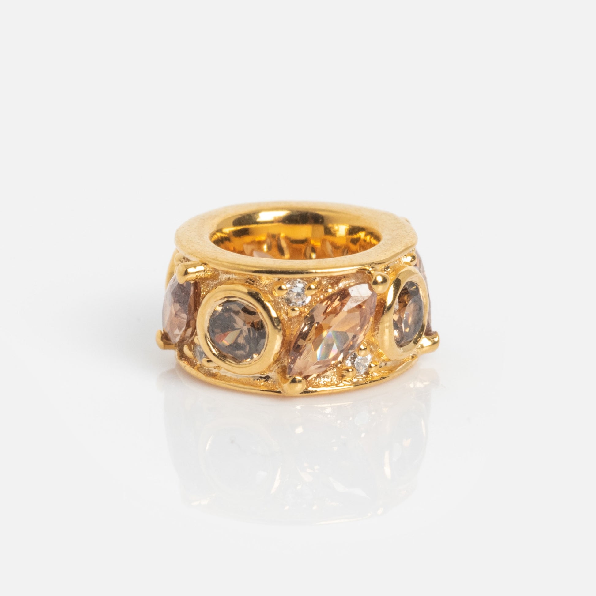 The Shades of You Birthstone Spacer Charm features round and marquise-shaped brown and clear gemstones, shown against a plain white background.