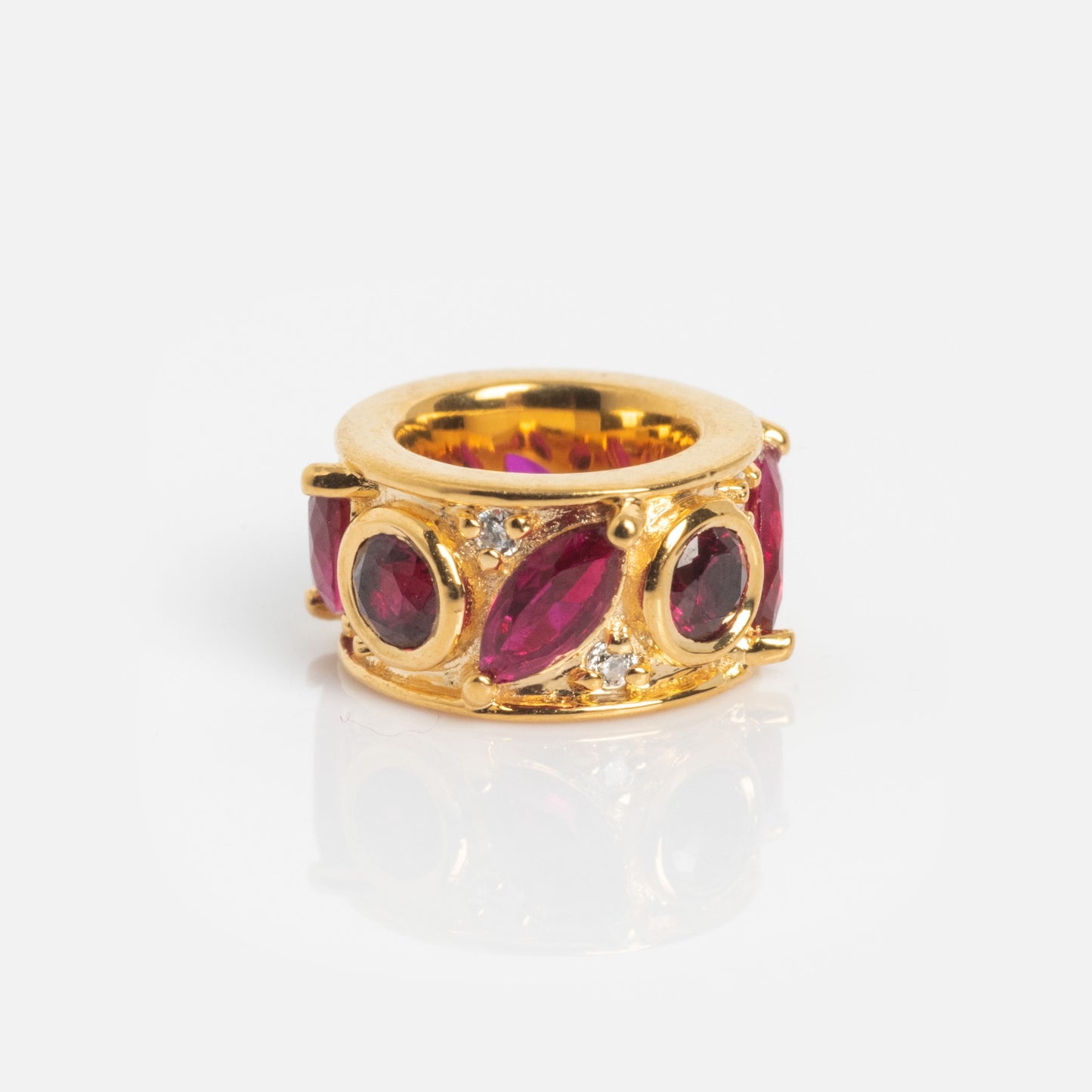 The Shades of You Birthstone Spacer Charm features large oval red gemstones and small clear stones in an ornate gold setting, displayed on a white background.