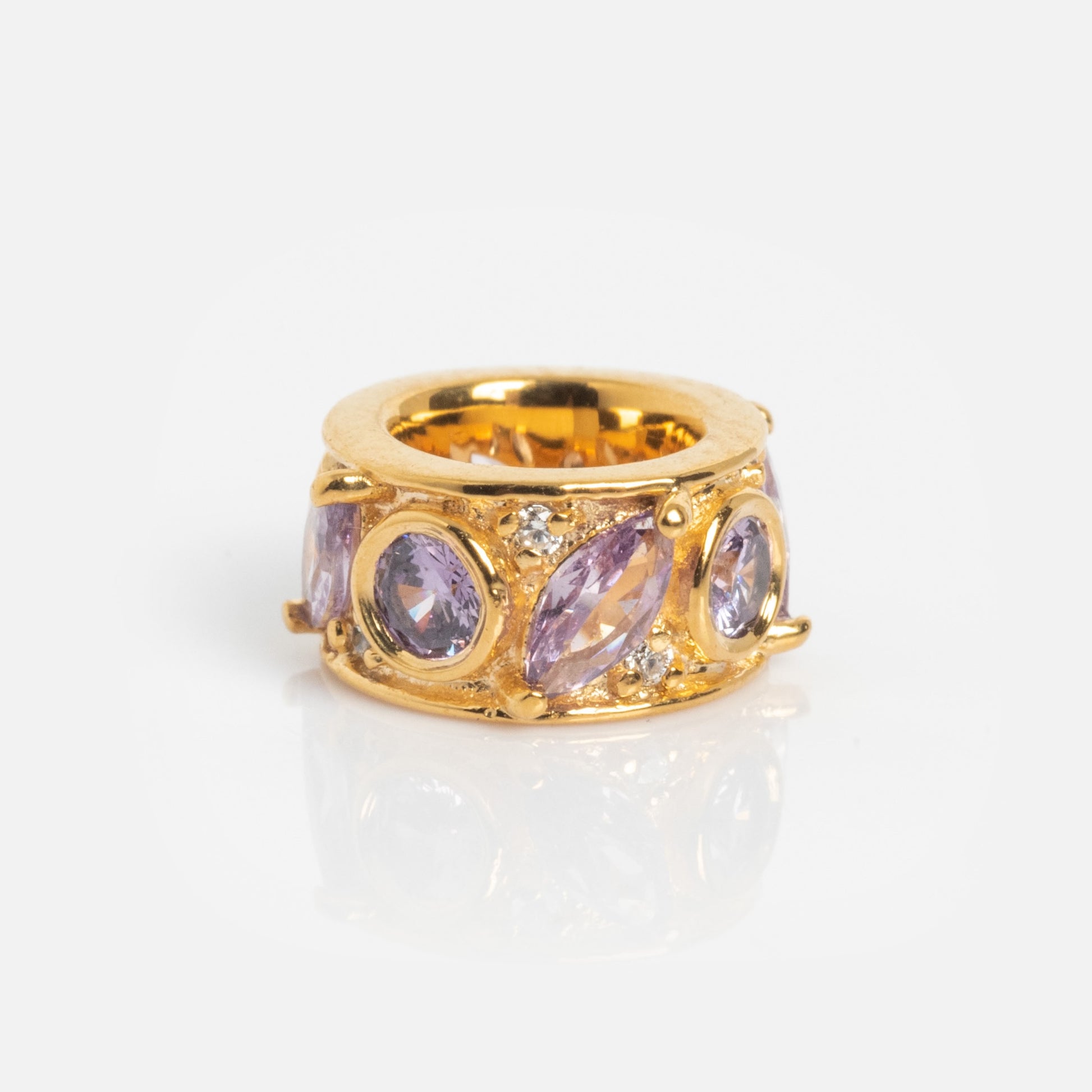 The Shades of You Birthstone Spacer Charm is a gold ring adorned with marquise and oval purple stones, accented by small clear gems and shown on a plain white background.