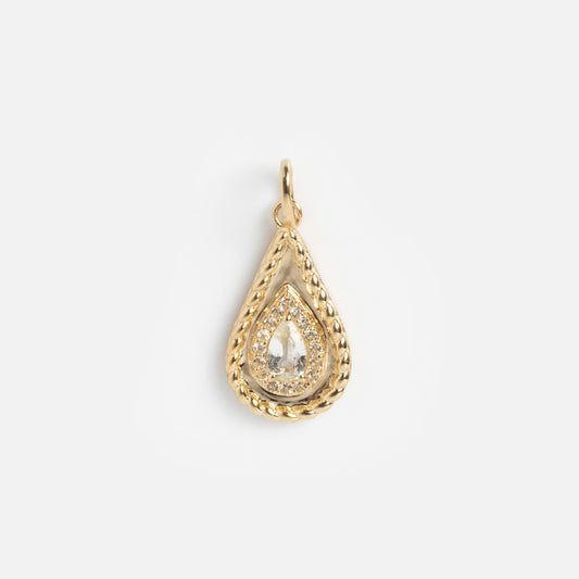 The Solid Gold 2026 April Capsule Tethered Teardrop White Topaz Charm features a central white topaz in a gold teardrop with a braided border, accented by small diamonds, set against a plain white background.