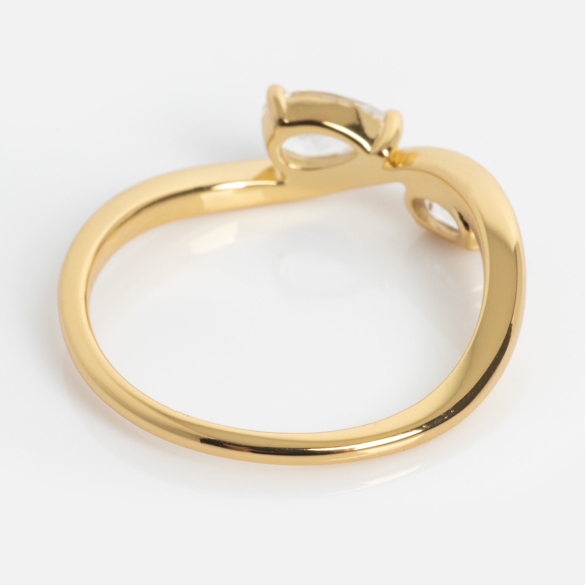 The 2026 April Capsule Floating Duo White Topaz Ring features a modern yellow gold vermeil twisted band, a single oval-cut white topaz gemstone, and an open asymmetrical setting against a white background.