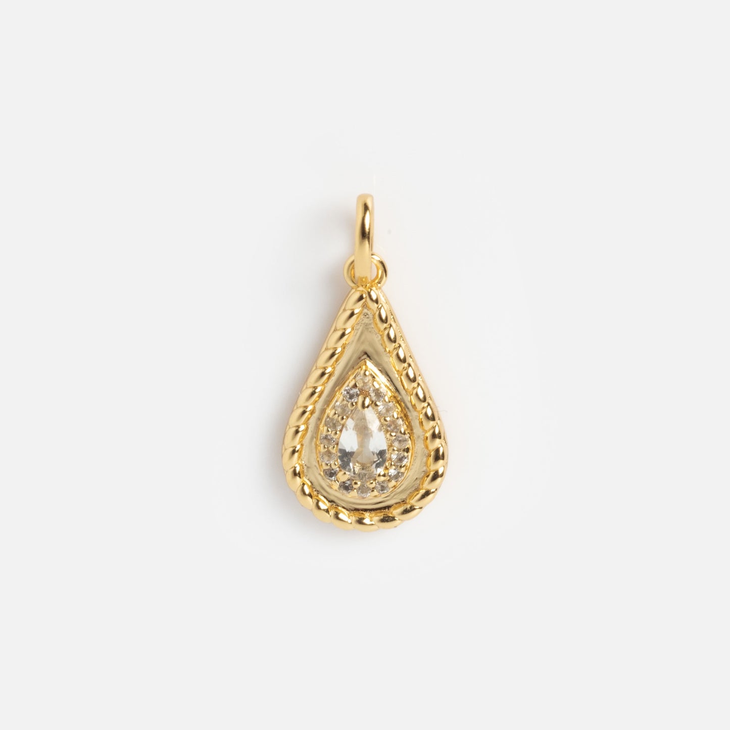 The 2026 April Capsule Tethered Teardrop White Topaz Charm features a yellow gold vermeil, teardrop-shaped pendant with a textured border and clear faceted white topaz—an elegant April birthstone charm on a plain white background.
