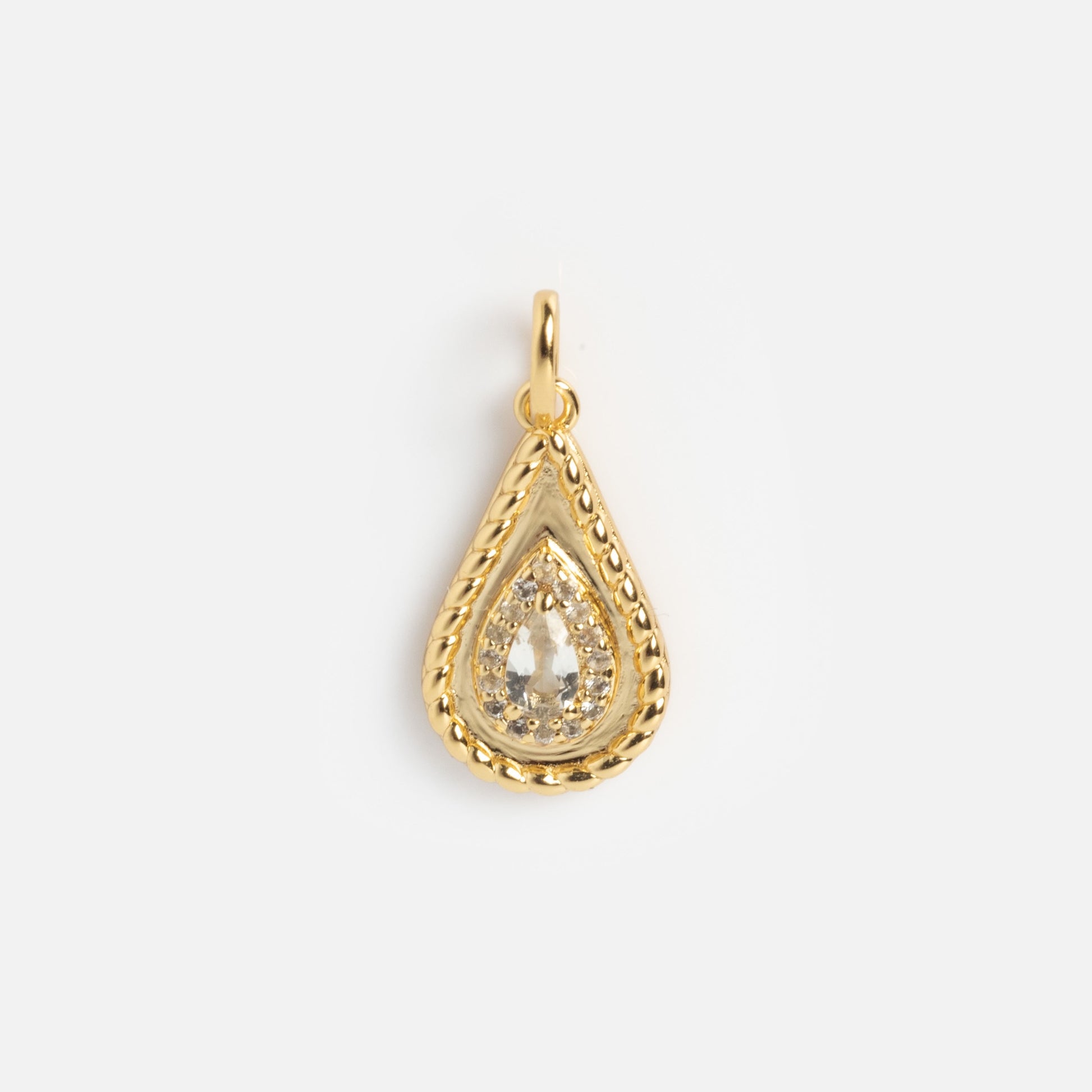 The 2026 April Capsule Tethered Teardrop White Topaz Charm features a yellow gold vermeil, teardrop-shaped pendant with a textured border and clear faceted white topaz—an elegant April birthstone charm on a plain white background.