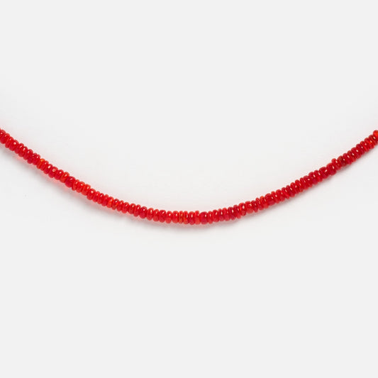 The Beaded Gemstone Necklace features small, round, vivid red beads strung closely together in a single strand, capturing crystal-inspired elegance against a plain white background.