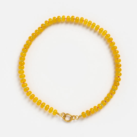 The Sale! Beaded Gemstone Charm Holder Necklace features round yellow beads and a gold clasp, beautifully arranged in a circle on a white background—an elegant accessory that adds charm to any outfit.