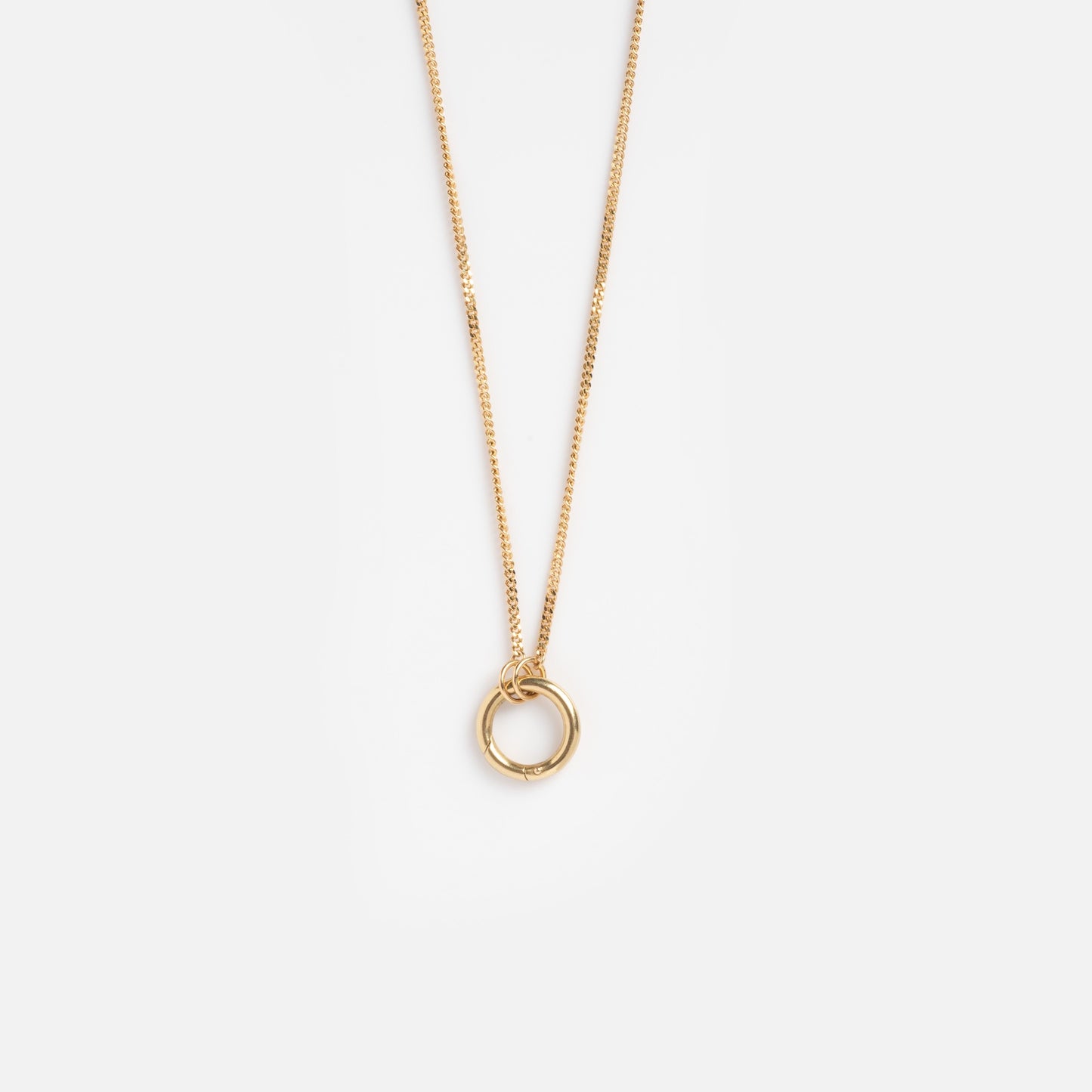 The Solid Gold Perfect Start Charm Holder Necklace features a simple 9k gold circular pendant, ideal for charm stacking, and is displayed against a plain white background.